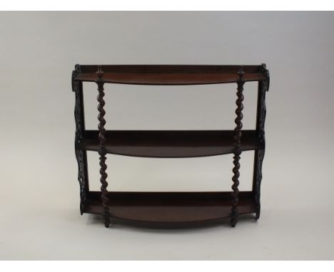 A Victorian mahogany three height wall shelf mid 19th century with barley twist pilasters and open work foliate brackets, 65c