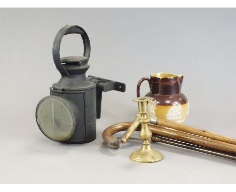 Three boxes containing an LMS railway lamp, a coaching lamp, a shoe last, a brass jam pan, a paraffin lantern, brass candlest