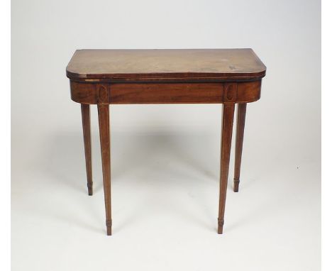 A George II mahogany and satinwood cross banded card table, the fold over top with rounded front corners raised on square tap