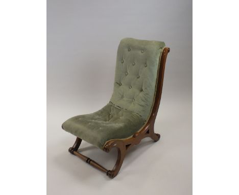 A Victorian walnut framed nursing chair with later upholstered Dralon button back and seats on a curvilinear X-frame