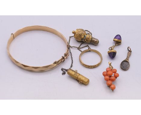 A quantity of various jewellery, to include: a 1/5th 9 ct gold bangle, a coral grapevine brooch, a miniature lorgnette case, 