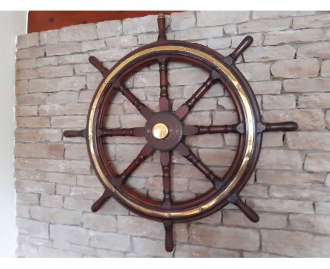 A brass bound teak ship's wheel, with wall fixing bracket and brass center cap, 94cm dia.