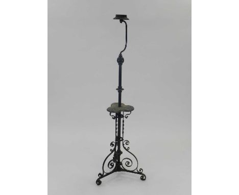 An Edwardian wrought iron lamp standard, the knopped stem with central trefoil wood tier, raised on three scroll feet, 161cm 