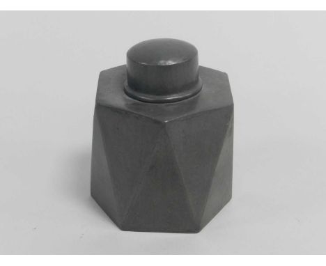 A Tudric pewter tea caddy and cover for Liberty and Co, stamped 01554, of faceted and planished hexagonal form 9cm high