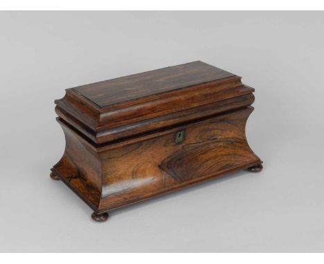 A 19th Century rosewood tea caddy, of sarcophagus form, the interior with two tea boxes flanking a mixing recess, lacking bow