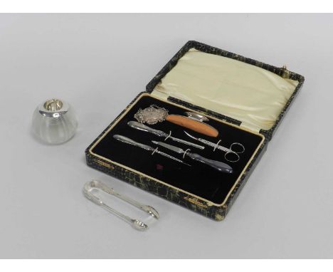 A cased silver mounted manicure set, Samuel M Levi, Birmingham 1917, together with a Scottish silver decanter label, Glasgow 