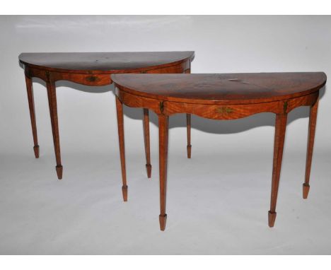 A pair of 19th century, Neoclassical style, demi-lune, satinwood console tables, painted in the Neoclassical style with class
