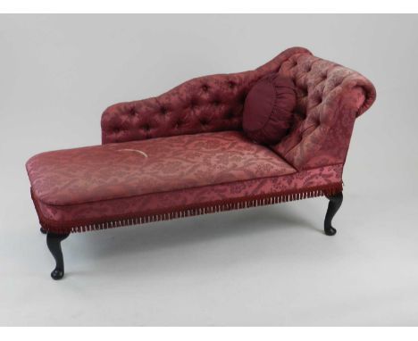 A reproduction Edwardian style chaise longue, with scroll form button back in raspberry brocade fabric, raised on cabriole su