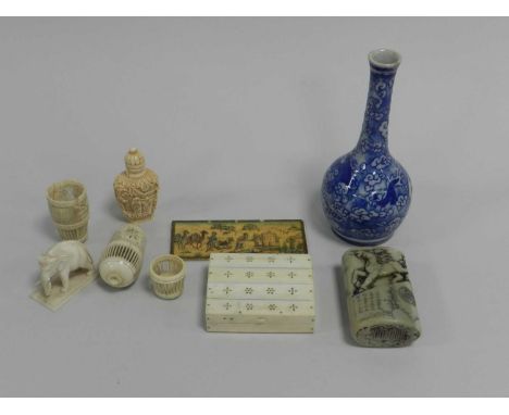 An assembled group of Asian works of art, 19th Century and later, including two carved bone gaming companions, a carved ivory