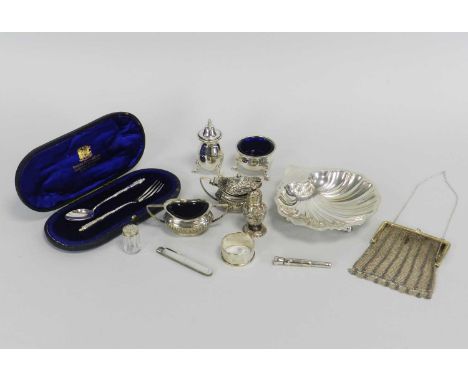 A silver shell form bowl, Chester 1911, together with a cased three piece silver cruet set, comprising; salt and two pepperet