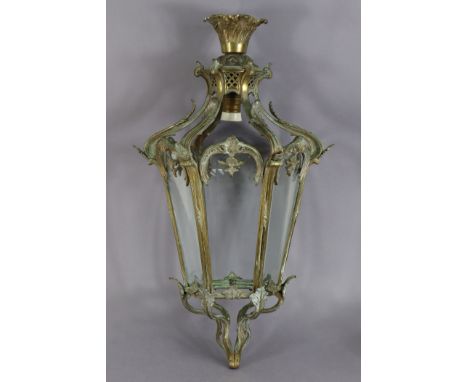 An antique cast-brass hall lantern of tapered hexagonal form with pierced foliate designs, inset six bevelled glass plates, 1