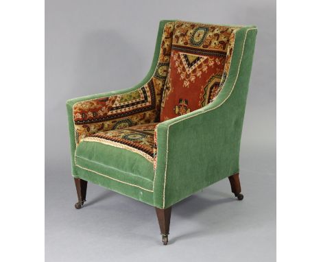 An Edwardian square armchair part upholstered in Persian pattern rug sections &amp; green velour, on square tapered legs with