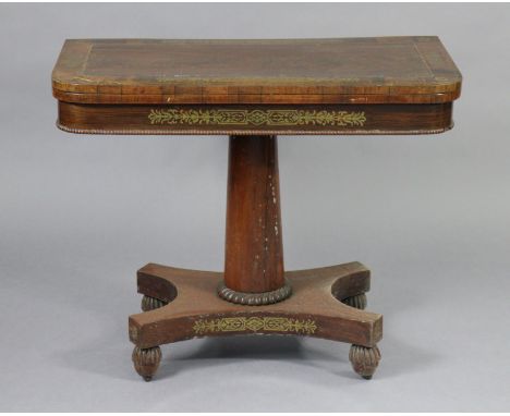 An early 19th century brass-inlaid card table, with rounded corners to the rectangular top, inset green baize, on wide tapere