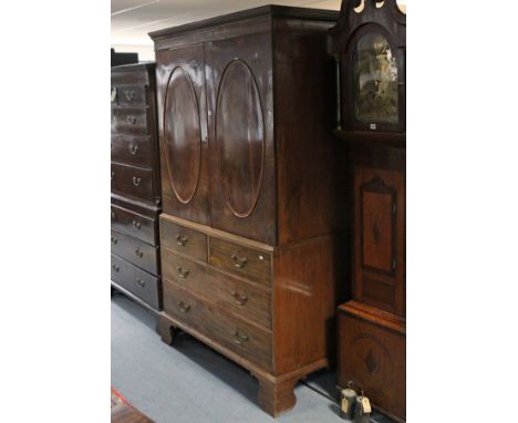 A 19th century inlaid mahogany wardrobe (converted from a linen press) with dentil cornice above a hanging compartment enclos