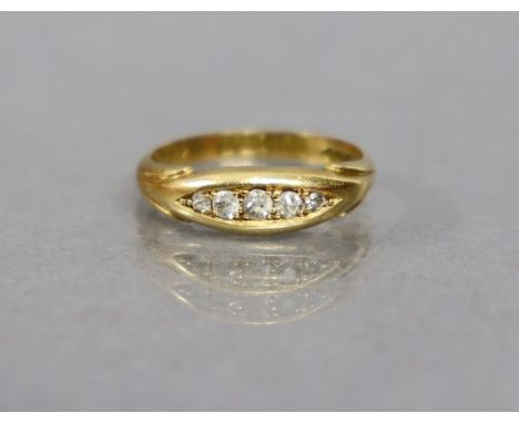 An 18ct. gold ring set row of five small graduated diamonds; size: K; weight: 3 gm.