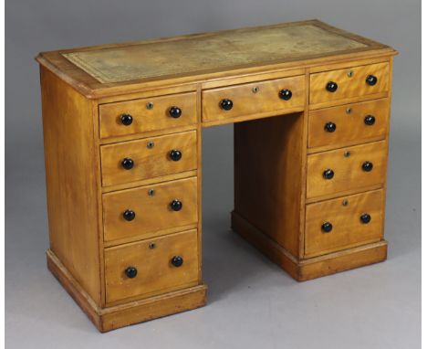 A Victorian satin birch pedestal desk, inset gilt-tooled tan leather to the rectangular top, fitted nine graduated drawers wi