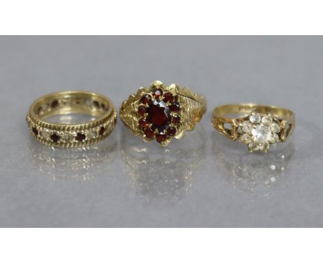 A 9ct. gold dress ring set garnet cluster, size: O; weight: 3.5 gm; another set cluster of white stones, size: L; weight: 1.9