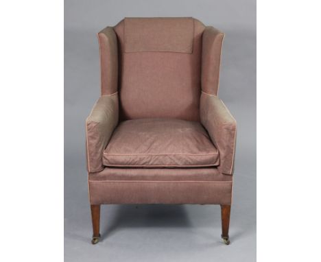 A late Victorian wing-back armchair, upholstered mauve silk fabric, on square tapered mahogany legs with ceramic castors, 27½