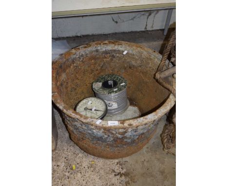 Large iron bowl together with some scales and electrical wiring