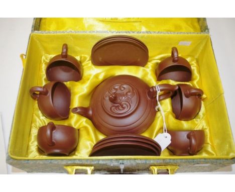 Boxed Chinese YiXing teaset (2001) including teapot, with ornamental lid, and 6 each cups and saucers, each piece with charac