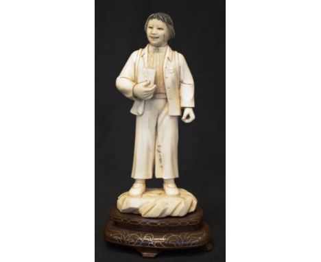Chinese ivory figure of boy with satchel circa 1917, on later stand. Figure 16cm high. NB This item may not be exported.
