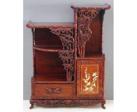 Good small Chinese rosewood cabinet ornately carved with bamboo stick and leaves, door inlaid with mother of pearl. 73cm high