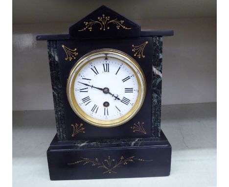 A late Victorian black slate mantel clock; the movement faced by an enamelled Roman dial  10''h       OS4