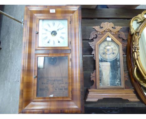 Early 20thC American clocks: to include a Waterbury Clock Company walnut cased example; faced by a painted Roman dial  30''h 