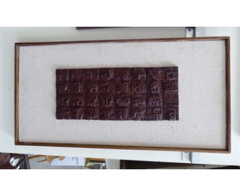 Ron Hitchings - a thirty-two abstract bronze effect collage, mounted on a painted board  bears a signature verso  5'' x 13'' 