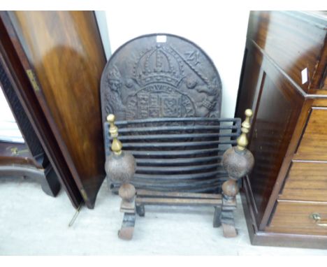 An early 19thC cast iron fireback, decorated with a coat of arms; a pair of later cast iron and brass fire dogs; and a grate 