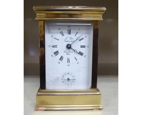 A modern lacquered brass carriage clock with bevelled glass panels and a swing top handle  inscribed 'Saint Sukanne'  5''h   