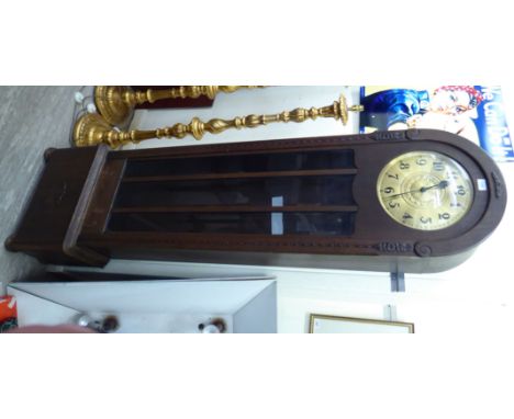 A 1920s stained oak longcase clock on a plinth and bun feet; the movement faced by a brass Arabic dial  77''h        RSF