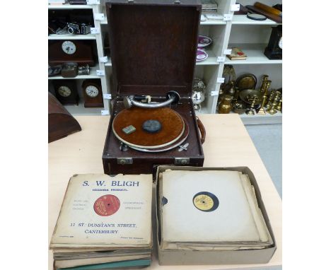 An early 20thC Columbia table-top gramophone, in a leather effect case  9''h  15''w; and a selection of 78rpm records        