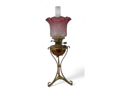 W.A.S. Benson Arts and Crafts copper and brass oil lamp with cranberry glass shade, complete. Marked for W A S Benson, Britis