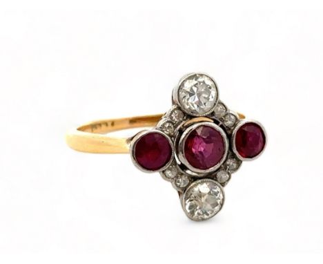 A ruby and diamond quatrefoil ring, size N, stamped 18ct. Two old cut diamonds each approx 0.3ct, eight single cut diamonds a