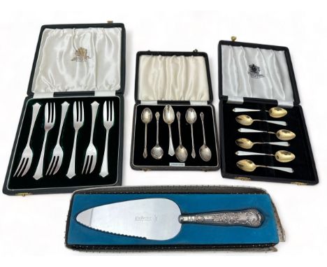 A cased set of silver tea spoons, a cased set of silver cake forks, a boxed cake slice with filled silver handle and a cased 