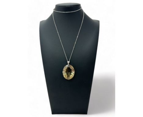 A large smoky quartz pendant on a mount stamped silver and suspended from a chain stamped silver. Quartz approx 35mm x 28mm. 
