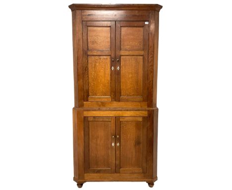 George III oak standing corner cupboard, stepped cavetto cornice over frieze with mahogany banding, top section fitted with t