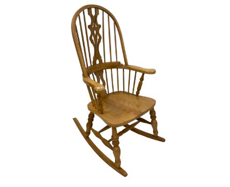 Beech rocking Windsor armchair, double bow back and stick back with pierced and shaped splat, dished seat, on turned supports