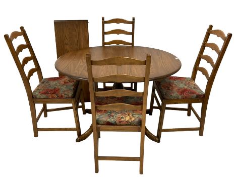 Ercol - elm oval extending dining table with additional leaf, on turned pedestal with four splayed cabriole supports (W111cm 