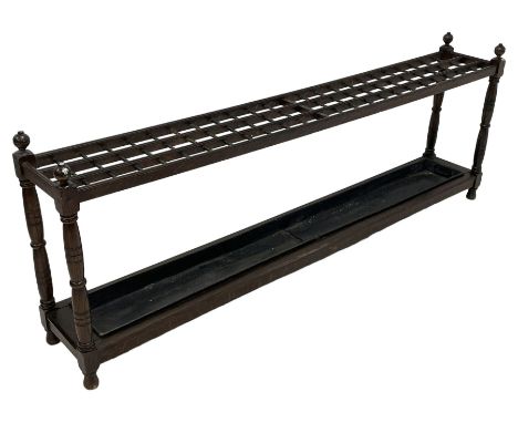 Large late 19th century oak stick or umbrella stand, on turned supports with globular finials, with metal drip tray, on turne