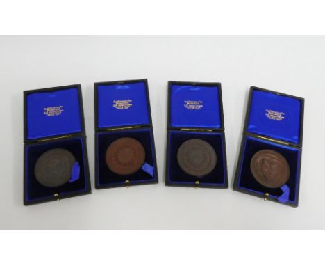 Four early 20th century bronze medallions, leather cased (4) 