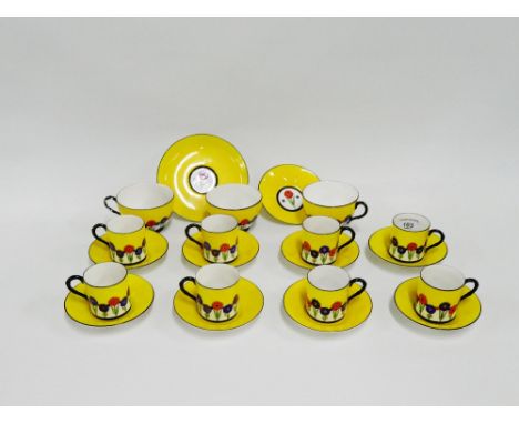 Royal Worcester Art Deco coffee cans and saucers with yellow glazed ground and black rims with a frieze of orange, purple and