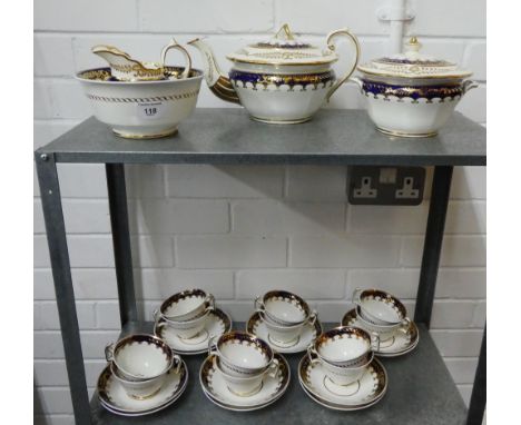 Rockingham style porcelain white glazed teaset with cobalt blue and gilt edged rims comprising twelve cups, eleven saucers, t