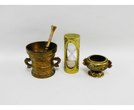 Chinese brass wares to include an egg timer, incense burner, together with a brass mortar and pestle, (4) 