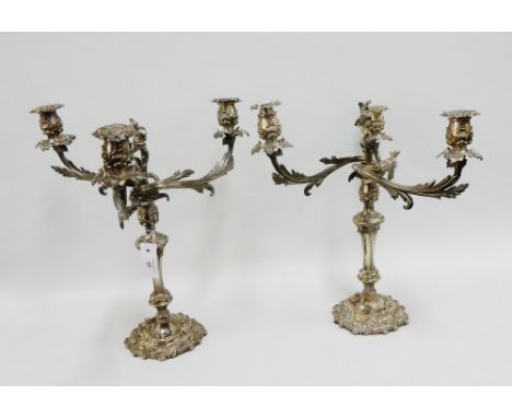 A large pair of 19th century silver plate on copper candelabra with three leaf scrolling branches and shell patterned sconces