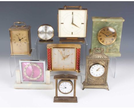 A Swiza gilt brass and red leather cased mantel alarm clock with eight day movement, the case with pierced sides, height 11.5