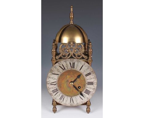 A 20th century brass lantern clock with eight day fusee movement, the silvered chapter ring with black Roman hour numerals an