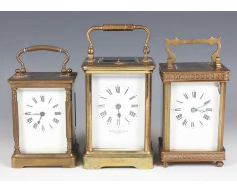 A 20th century lacquered brass corniche cased carriage clock with eight day movement striking and repeating on a gong, the wh