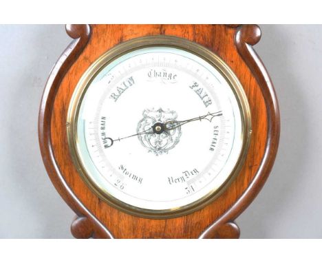 A Victorian walnut cased wheel barometer with opaline glass dial and thermometer dial, the case with applied scroll mouldings